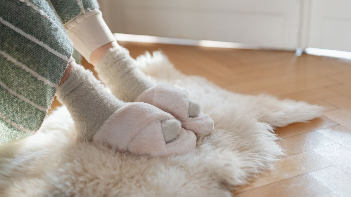 Chaussettes sans élastique et chaussons posés sur un tapis, lumière naturelle